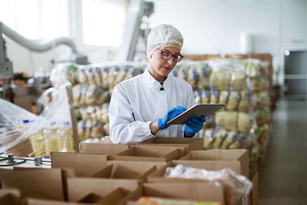 Person working in a warehouse with food